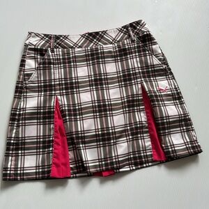 Puma dry cell pink, white and black plaid women’s golf skort.  Size 4